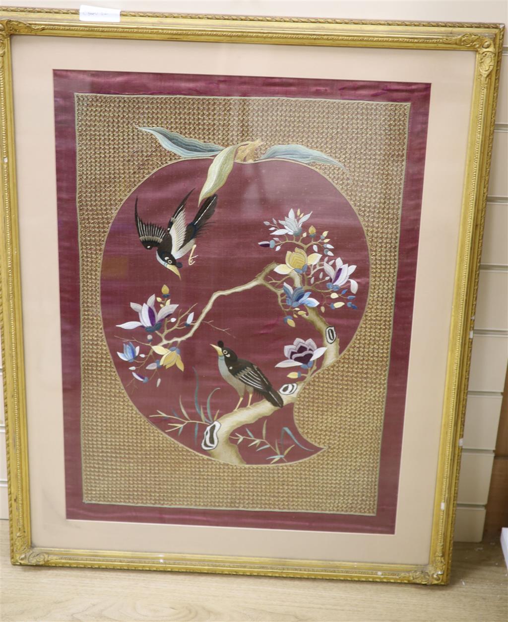 A Japanese silkwork panel of birds on a purple ground, width 48cm to the mounts height 57cm